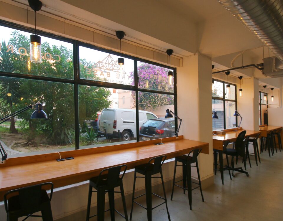 An amazing picture of Virtual Office's space at day show the beautiful day outside of the office though the big glass window